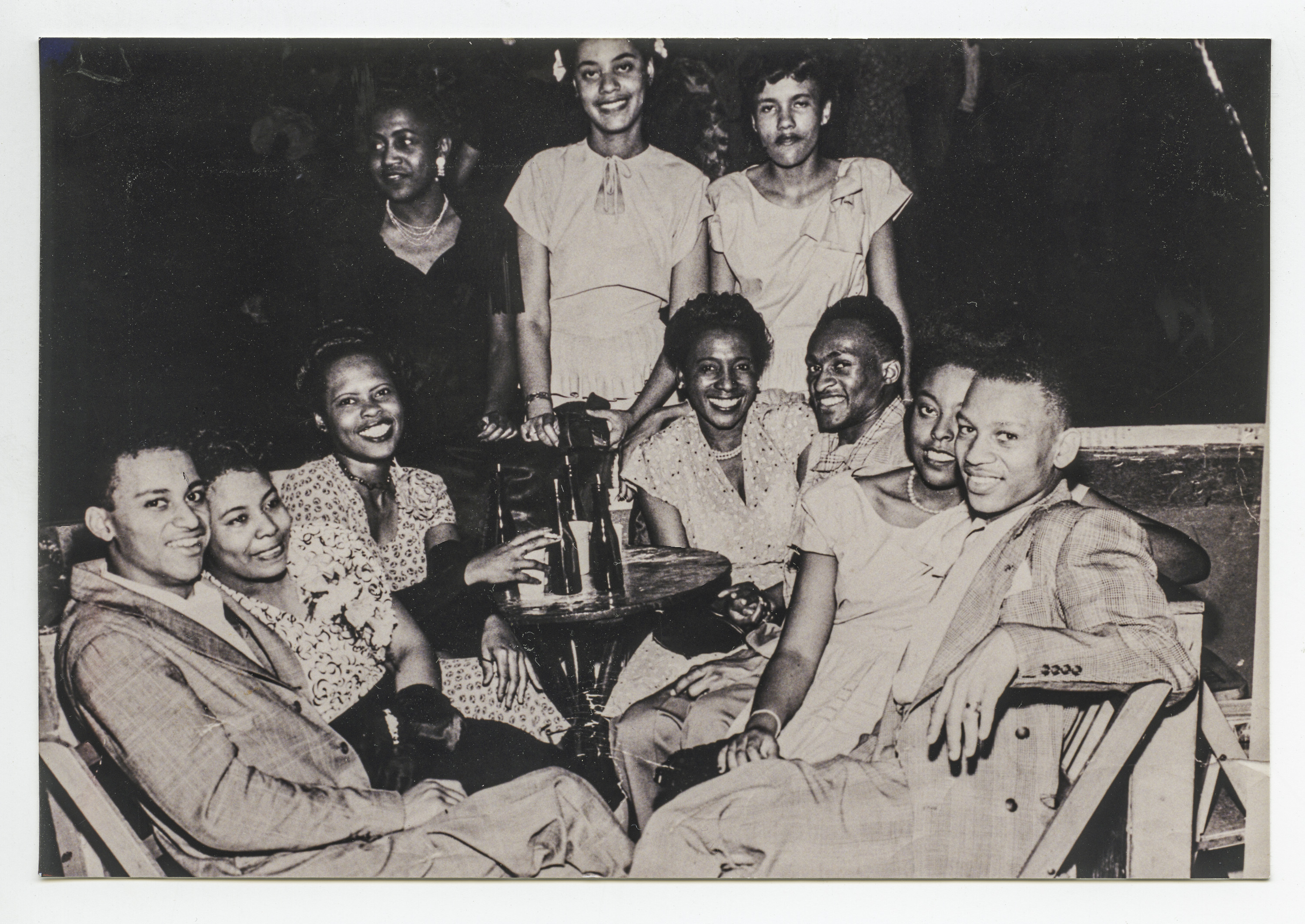Carmen (2nd to right, seated) with Glenna Rohan (middle, standing) and friends at cocktail party on Lenox Avenue in Harlem, NY in the 1940s.